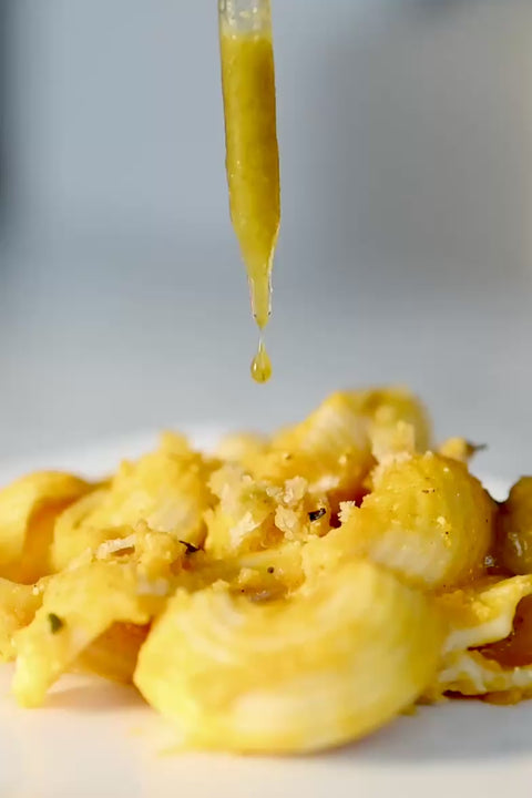 fiamma drops hot dropping onto mac and cheese in slow motion from the glass dropper